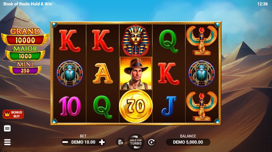 The main game screen of Book of Reels Hold & Win, showing the 5x3 reel layout against a desert pyramid backdrop.