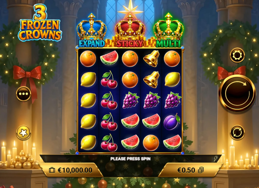 3 Frozen Crowns slot base game 5x5 grid with frozen fruit symbols and Christmas tree background.