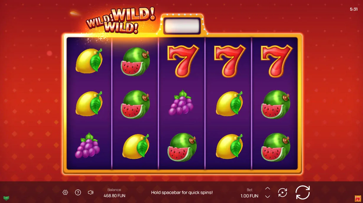 A view of the Wild! Wild! WILD! 5x3 game grid during base gameplay, displaying the fruit symbols and user interface.