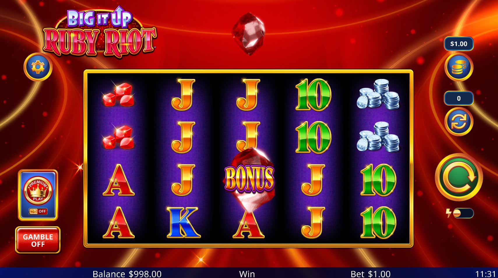 The 5x3 reel grid of the Big It Up Ruby Riot slot during base gameplay, showing high-value gem symbols and the player interface.