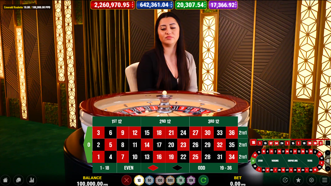 The live dealer at the Emerald Roulette table, with the European roulette wheel in focus, showcasing the immersive studio atmosphere created by Pateplay.